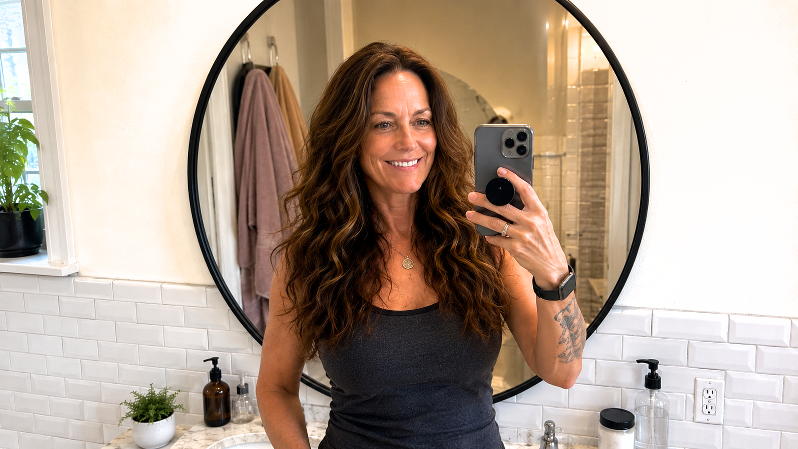 Woman taking a mirror selfie in a bathroom